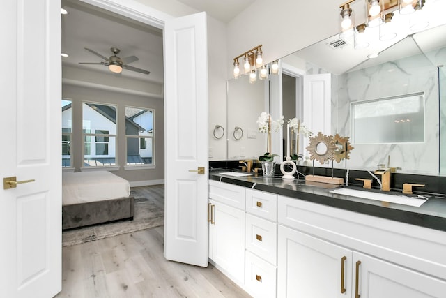 bathroom featuring ceiling fan, wood-type flooring, walk in shower, and vanity