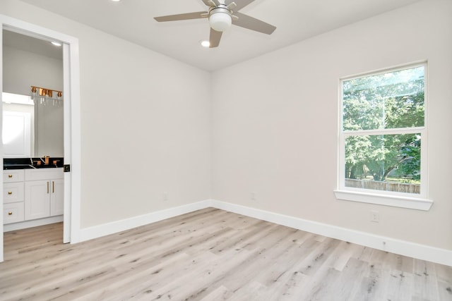 unfurnished bedroom featuring light hardwood / wood-style flooring, multiple windows, and ceiling fan