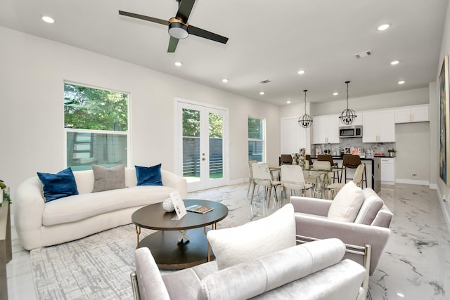 living room with french doors and ceiling fan