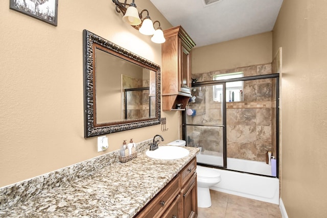 full bathroom featuring tile patterned flooring, vanity, toilet, and enclosed tub / shower combo