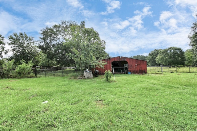 view of yard with an outbuilding and a rural view