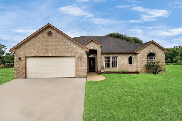 view of front of home with a front lawn and a garage