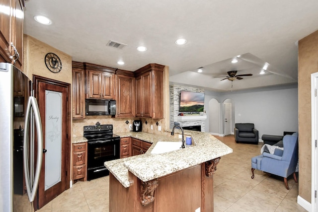 kitchen with black appliances, sink, ceiling fan, tasteful backsplash, and kitchen peninsula