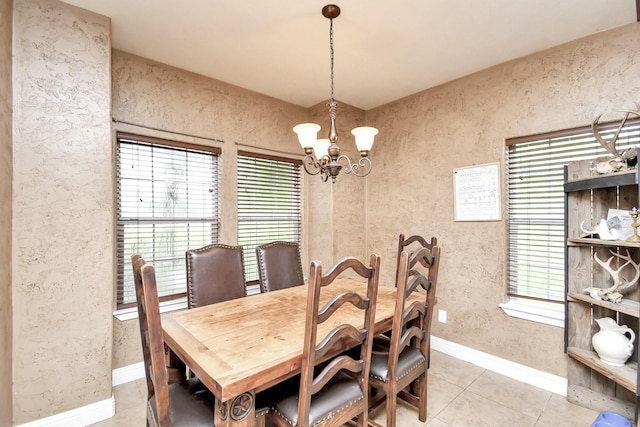 tiled dining space featuring a chandelier