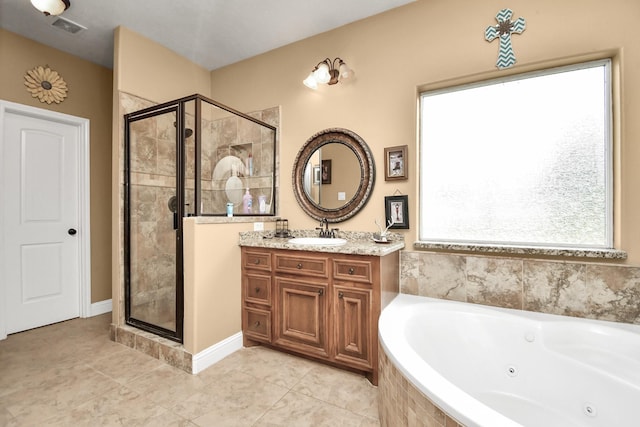 bathroom featuring tile patterned floors, vanity, and shower with separate bathtub