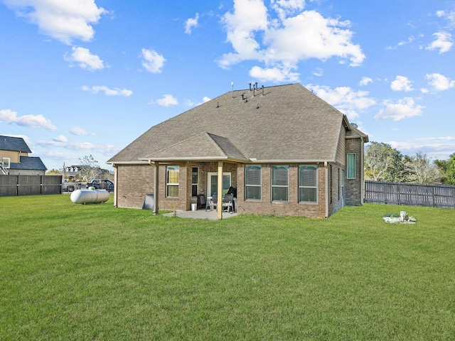 back of house with a yard and a patio area