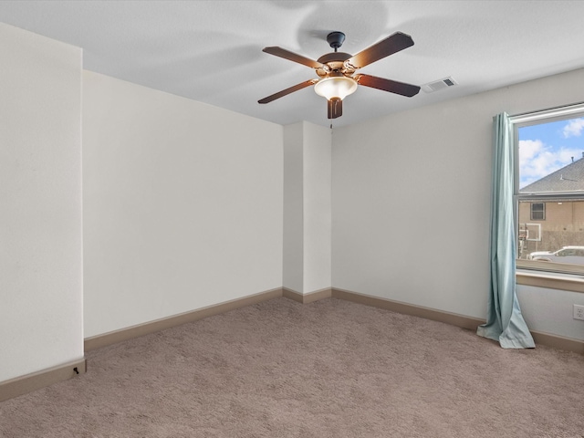 spare room with light carpet and ceiling fan