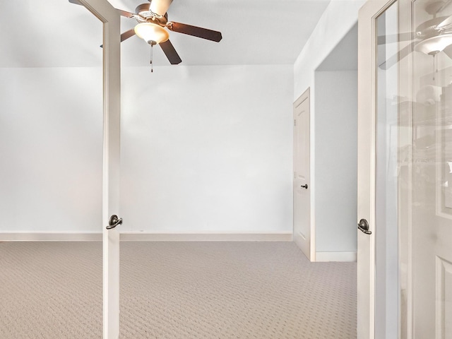 unfurnished room featuring ceiling fan and carpet