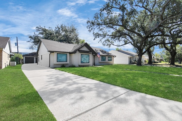 ranch-style home featuring a front yard, a garage, central AC unit, and an outdoor structure