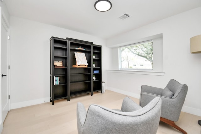 sitting room featuring wood-type flooring