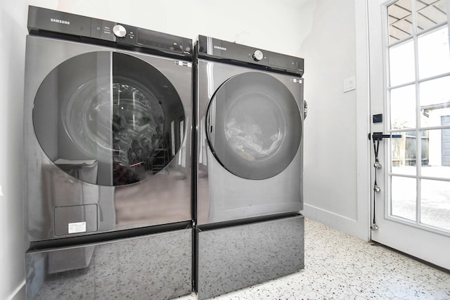 clothes washing area with independent washer and dryer