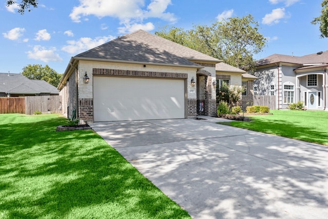 view of front of home with a garage and a front lawn