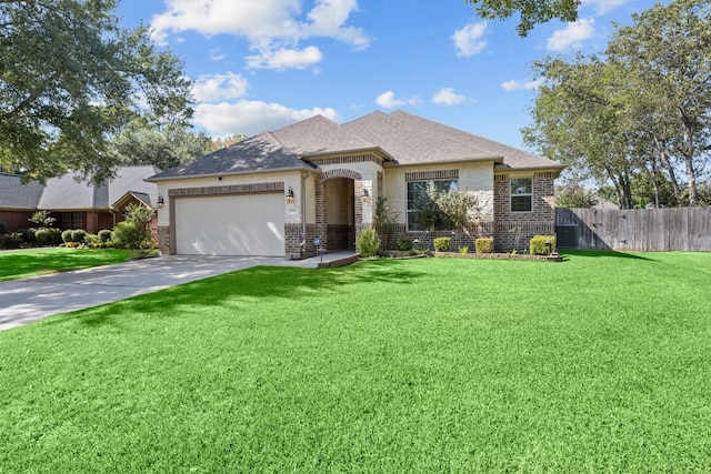 view of front of home featuring a front yard and a garage