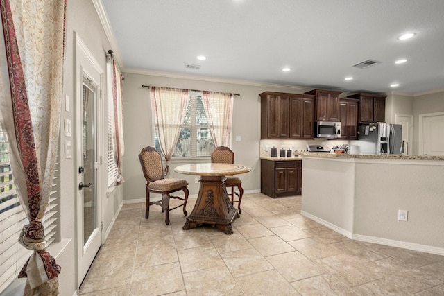 kitchen with dark brown cabinets, ornamental molding, and appliances with stainless steel finishes