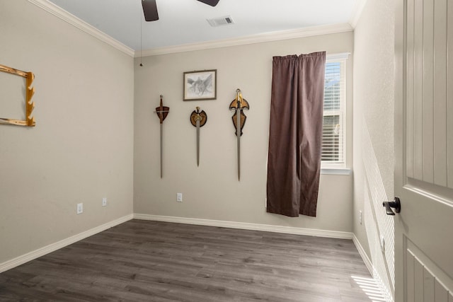 spare room with dark hardwood / wood-style floors, ceiling fan, and crown molding