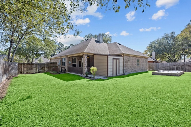 rear view of house featuring a yard and a deck