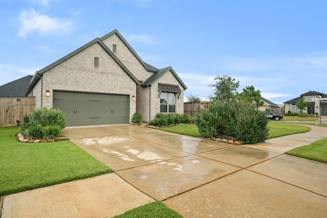 view of front of property with a front lawn and a garage