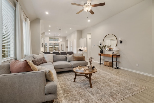 living room featuring ceiling fan and light wood-type flooring