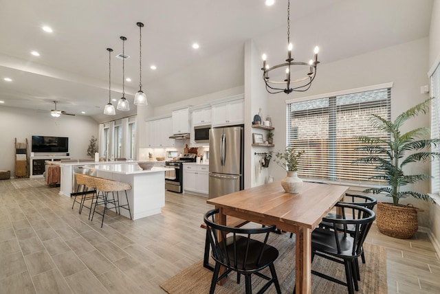 dining room with ceiling fan with notable chandelier