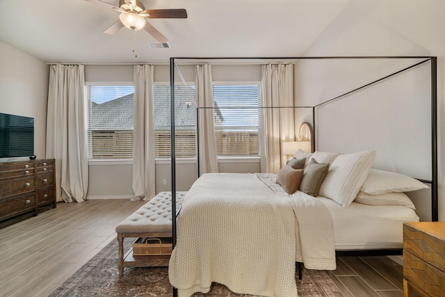 bedroom featuring multiple windows, ceiling fan, and hardwood / wood-style floors