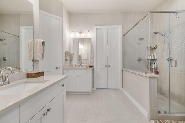 bathroom featuring vanity and a shower with door