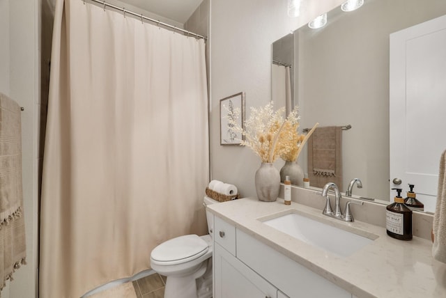 bathroom featuring tile patterned flooring, vanity, and toilet