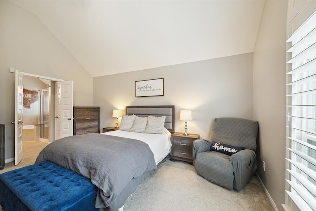 carpeted bedroom featuring ensuite bathroom and vaulted ceiling