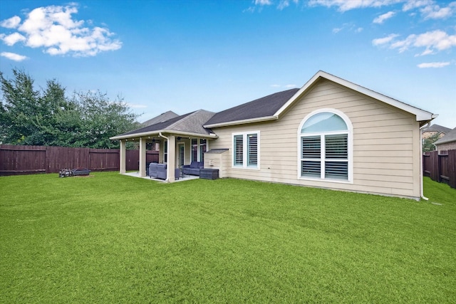 back of property featuring a lawn, a patio, and an outdoor hangout area