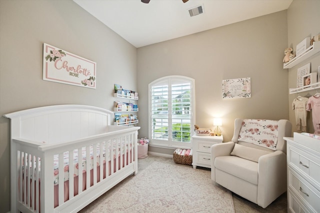 bedroom featuring ceiling fan and a nursery area