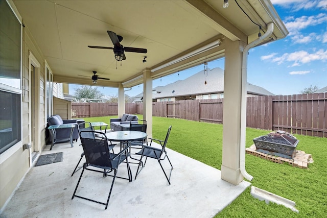 view of patio with ceiling fan and an outdoor fire pit