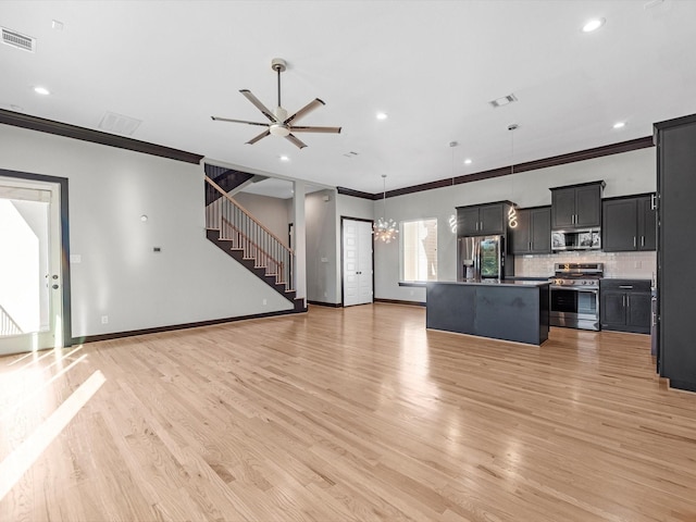 unfurnished living room featuring ornamental molding, ceiling fan with notable chandelier, and light wood-type flooring