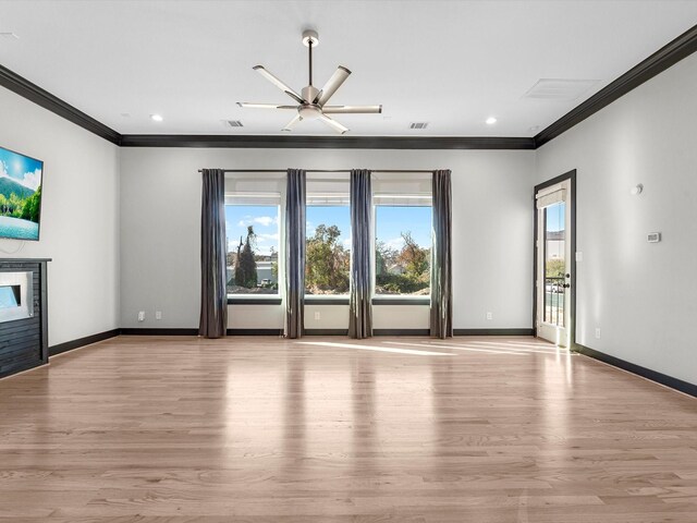 unfurnished living room with crown molding, ceiling fan, and light wood-type flooring