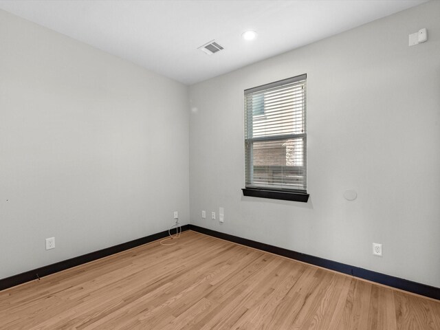 spare room featuring wood-type flooring