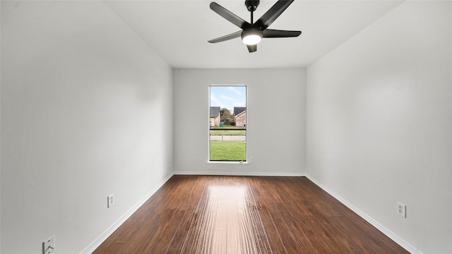 empty room with ceiling fan and dark wood-type flooring