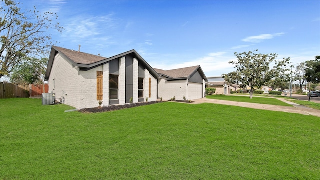 view of home's exterior featuring a garage, a yard, and central AC