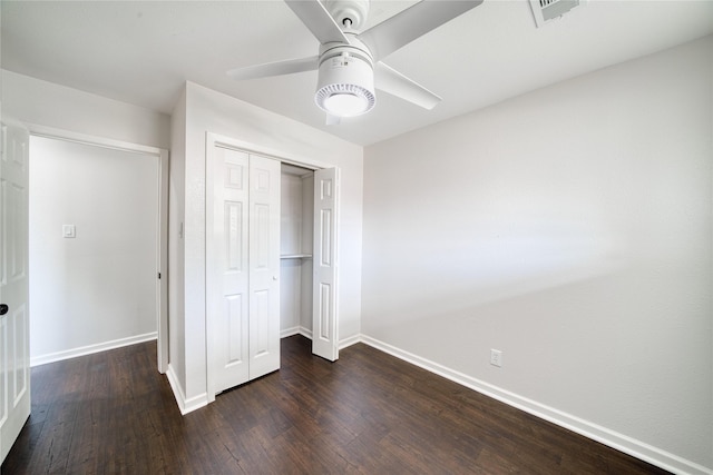 unfurnished bedroom with a closet, dark hardwood / wood-style floors, and ceiling fan