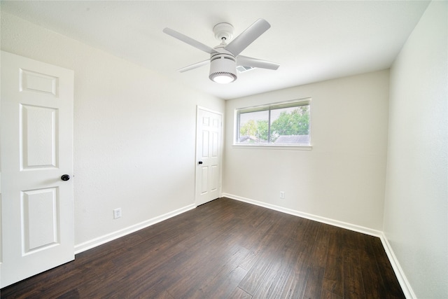 spare room with ceiling fan and dark wood-type flooring