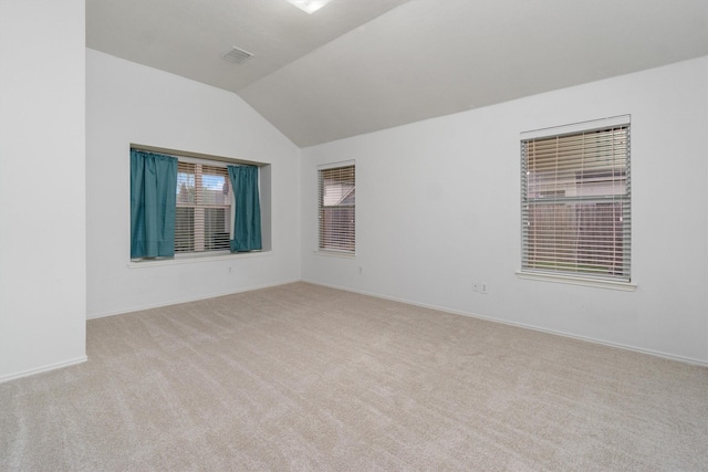 unfurnished room with light carpet and lofted ceiling