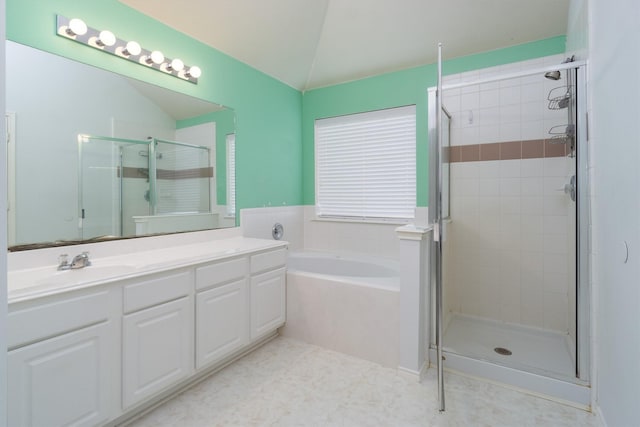 bathroom featuring vanity, vaulted ceiling, and shower with separate bathtub