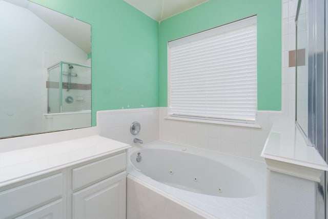 bathroom with separate shower and tub, vanity, and vaulted ceiling