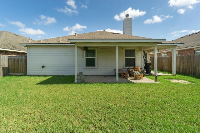 rear view of house with a lawn and a patio area