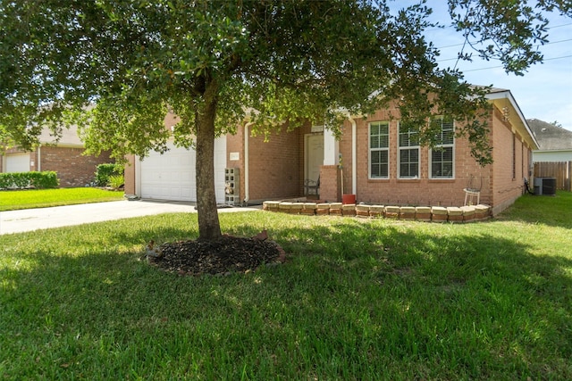 view of property hidden behind natural elements featuring a front lawn, a garage, and cooling unit