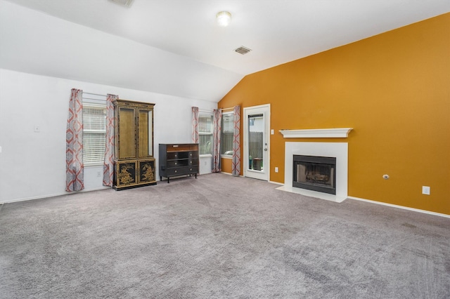 unfurnished living room featuring carpet flooring and lofted ceiling