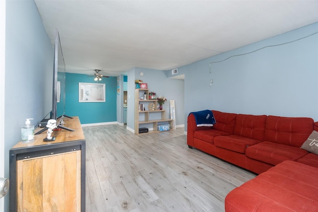 living room featuring ceiling fan and hardwood / wood-style floors