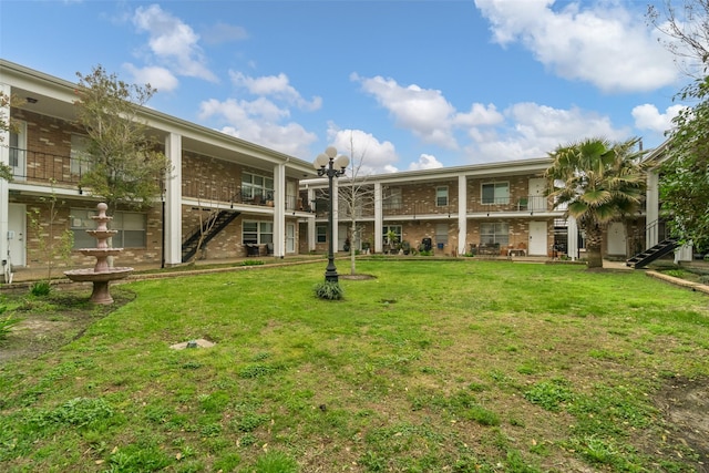 view of home's community with a lawn