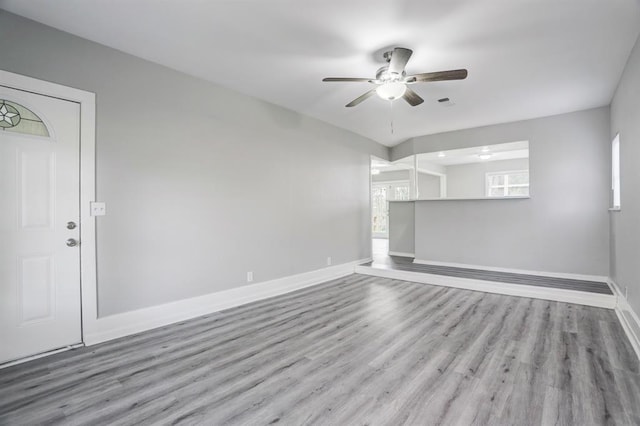 unfurnished living room featuring ceiling fan and light hardwood / wood-style flooring