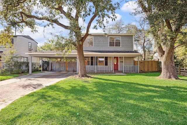 view of property featuring covered porch, a carport, and a front yard