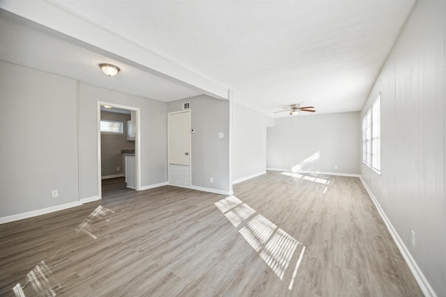 unfurnished living room with ceiling fan, plenty of natural light, and light hardwood / wood-style flooring