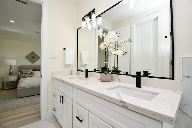 bathroom with a chandelier and vanity