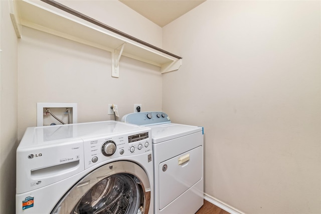 washroom featuring hardwood / wood-style floors and separate washer and dryer